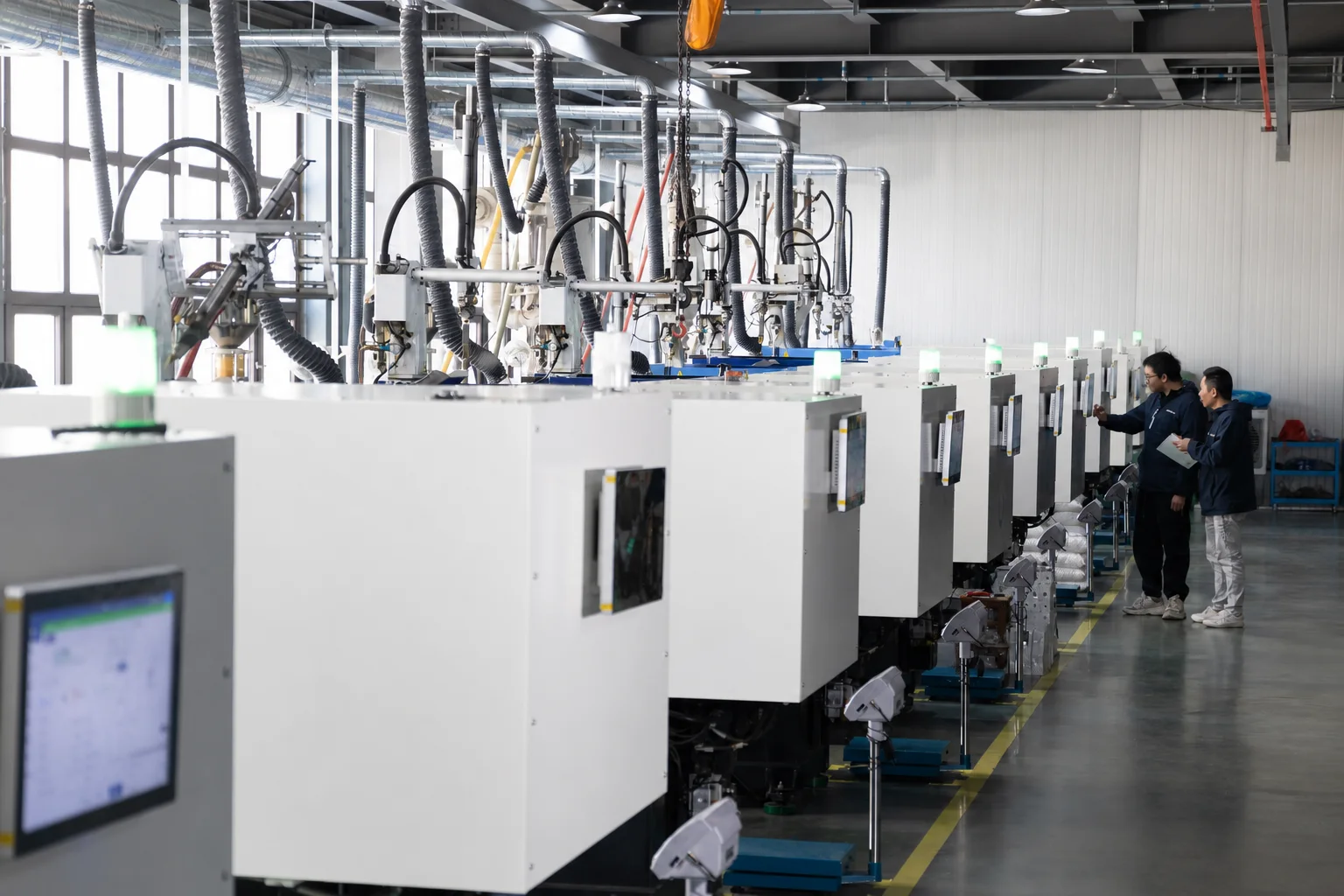 VIOX team reviewing production equipment and partner supply requirements in the factory