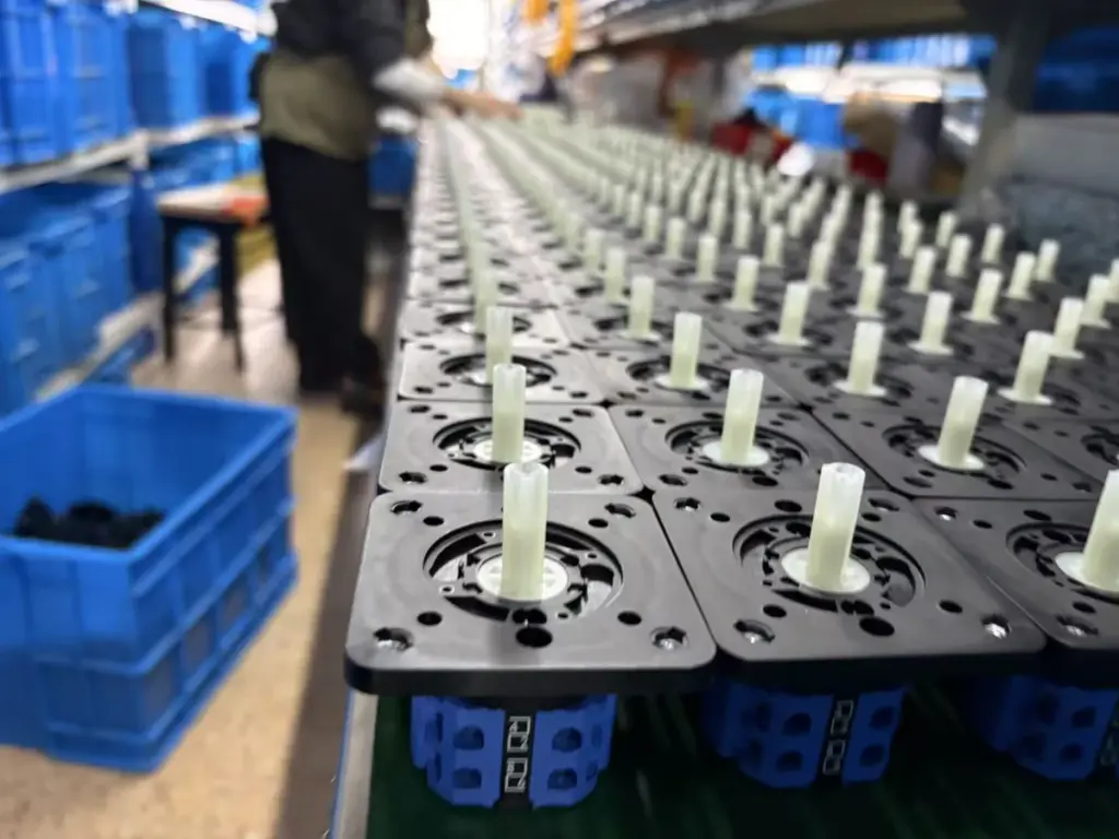 Rotary cam switch bodies and shafts staged for assembly in the VIOX workshop